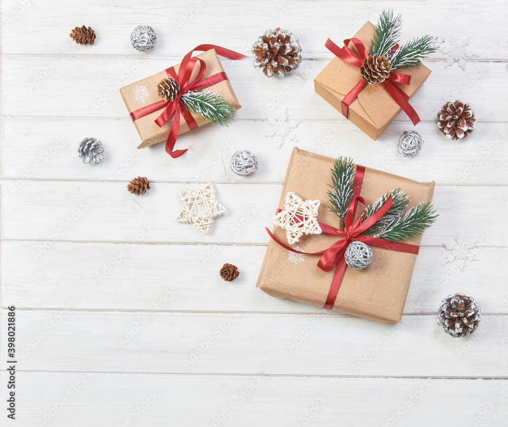 Christmas gifts boxes on a white wooden background with decor. Christmas gifts boxes on a white wooden background with decor.