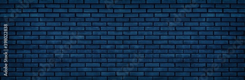 Navy blue brick wall wide texture. Dark block masonry large widescreen background. Gloomy night indigo backdrop © JAYANNPO