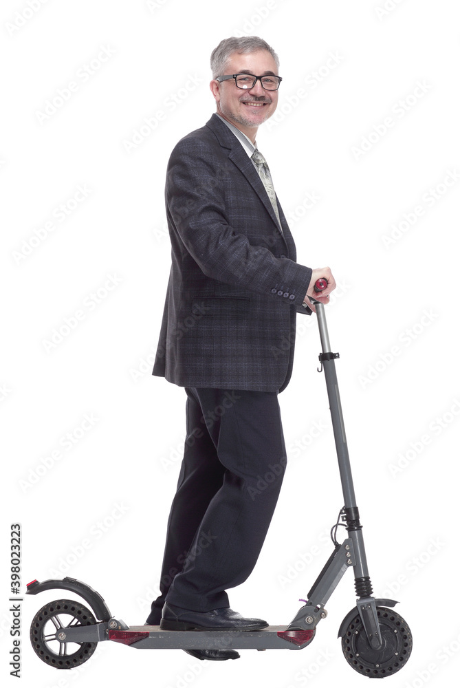 side view. Mature man with electric scooter looking at you side view. Mature man with electric scooter looking at you