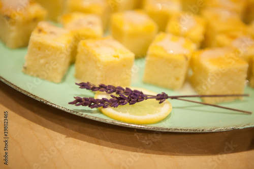 Still Life Sweet yellow lemon cake pieces with lavender decoration