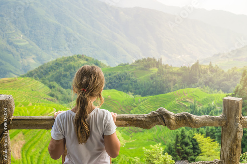 Cute young girl admiring Longji Rice Terraces