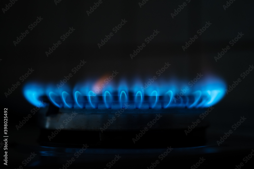 Blue flame gas in the dark. Gas switching on. Natural gas close up Blue flame gas in the dark. Gas switching on. Natural gas close up