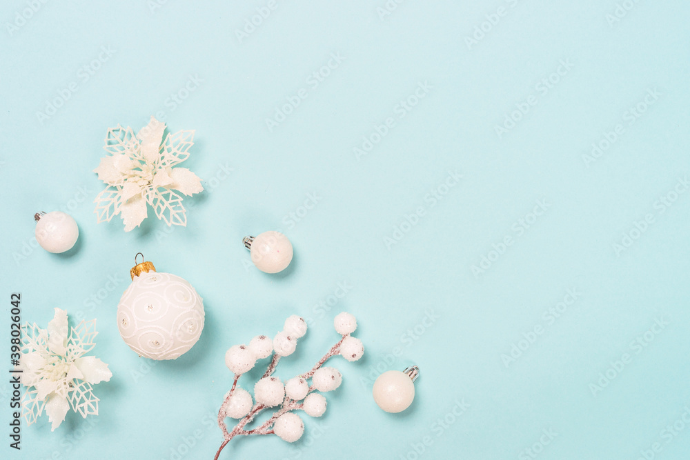 Christmas copmosition with white holidays decorations. Flat lay image on blue background.