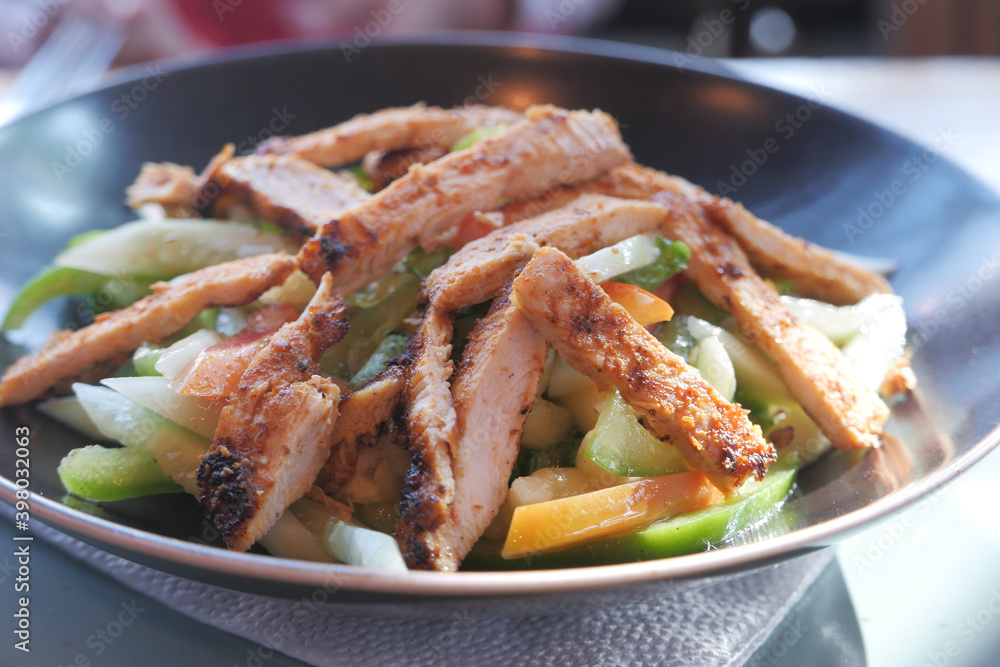 Grilled chicken and fresh vegetable salad on table. Grilled chicken and fresh vegetable salad on table.