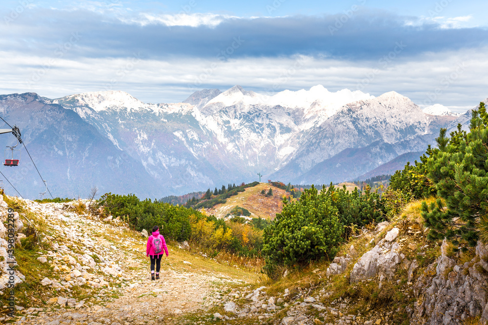 Woman walking hiking Velika Planina mountain, Slovenia.