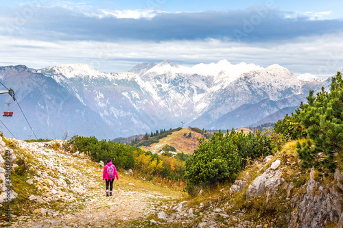 Woman walking hiking Velika Planina mountain, Slovenia.
