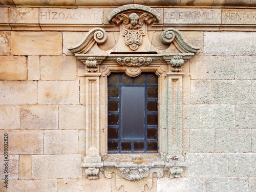 Window on the facade of a church in a town in Spain.