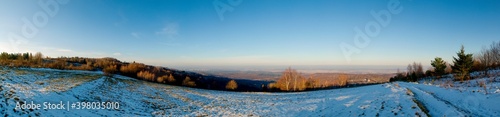 panorama of winter meadow  forest and clear sky in the mountains