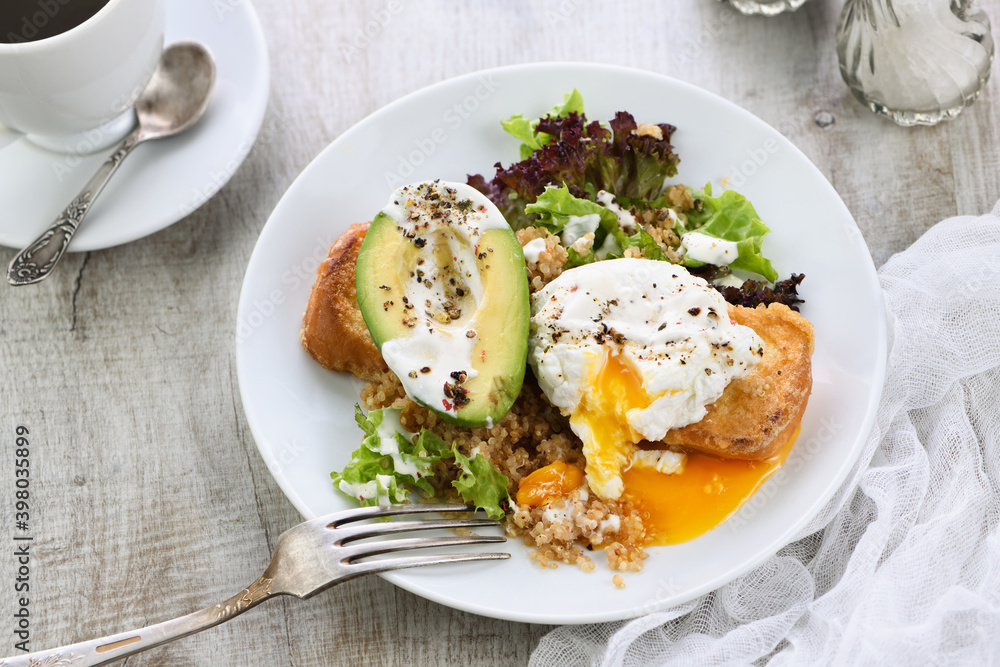 A healthy and balanced breakfast plate.
Benedict's egg spreads on a toasted toast with half an avocado, quinoa and lettuce, seasoned   spices and yogurt dressing. Enjoy the most important meal of the 