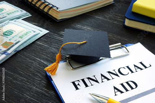 Graduation cap and financial aid for student form on the desk. photo