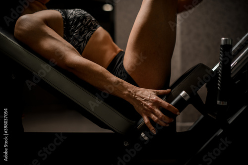 close-up of beautiful athletic muscular female arm and body on sports simulator © fesenko