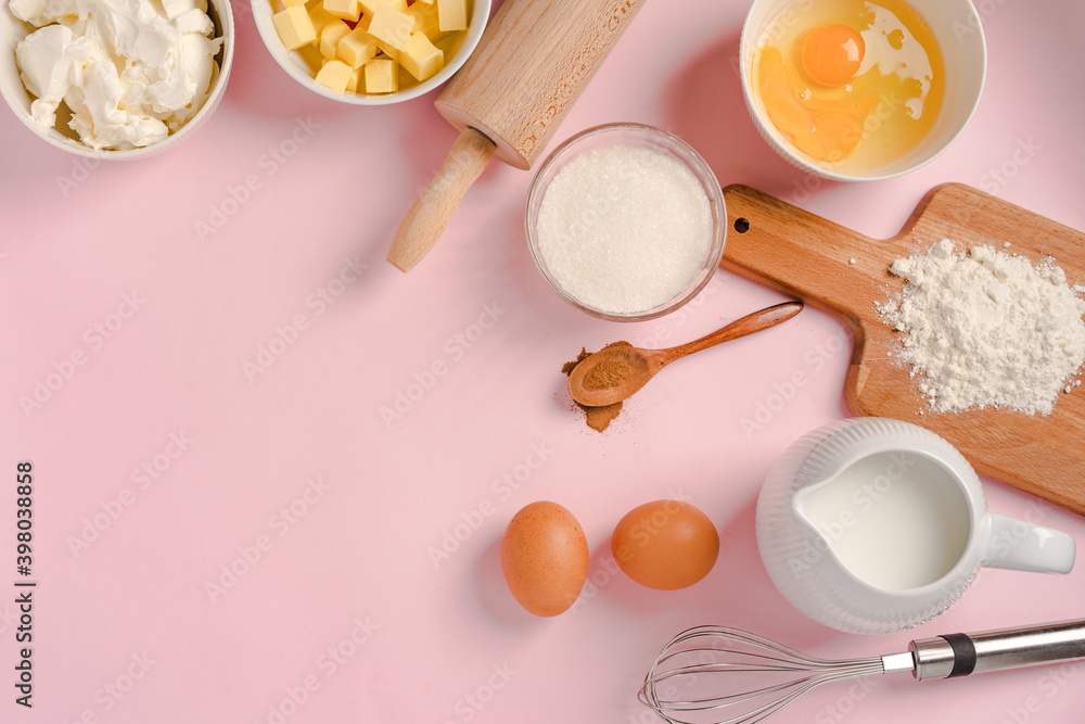 Baking ingredients and tools on a pink pastel background, top view. Cooking process and place for text Baking ingredients and tools on a pink pastel background, top view. Cooking process and place for text