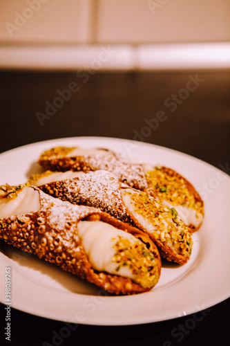 Cannoli are Italian pastries consisting of tube-shaped shells of fried pastry dough, filled with a sweet, creamy filling usually containing ricotta—a staple of Sicilian cuisine. Palermo, Sicily, Italy
