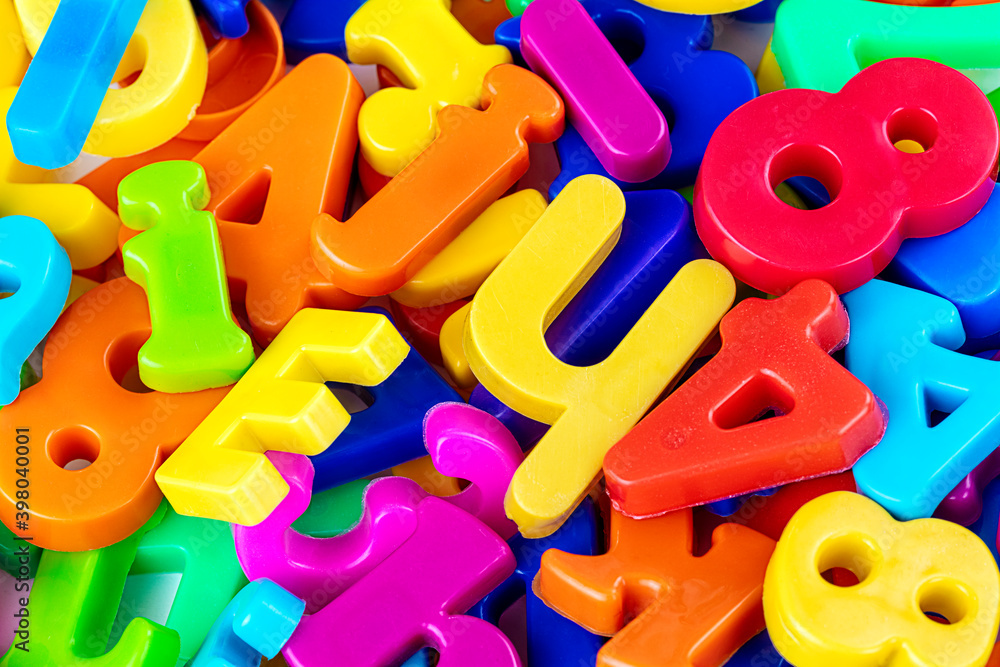 Mix of colorful alphabetical letters as a background, close up Mix of colorful alphabetical letters as a background, close up