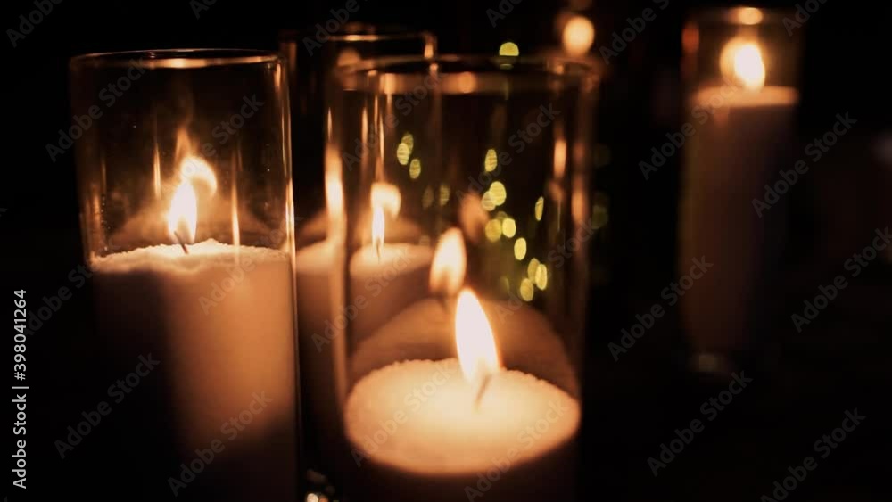 candles burn in the dark near the wedding arch candles burn in the dark near the wedding arch