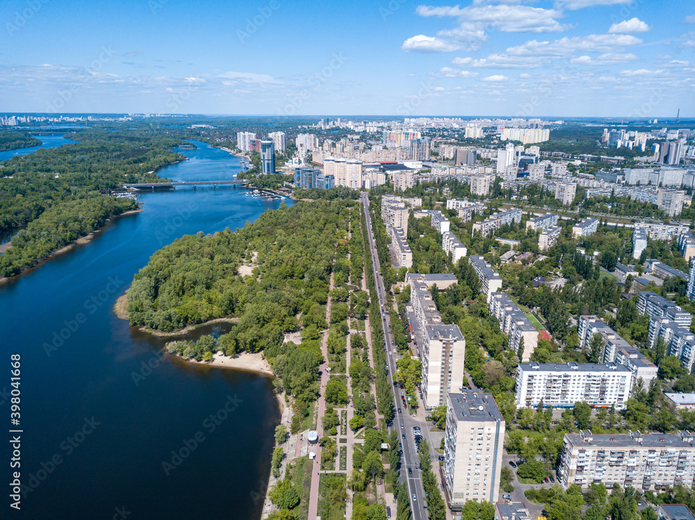 Fototapeta premium Aerial drone view. Residential buildings on the bank of the canal on a sunny day in Kiev.