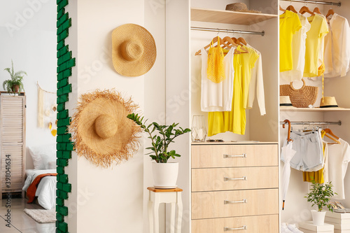 Photography Big wardrobe with different clothes and accessories in dressing room