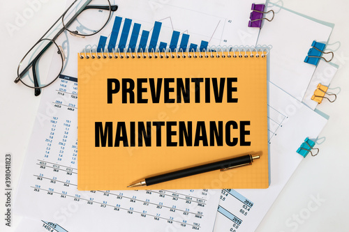 Preventive Maintenance is written on a notepad on office desk