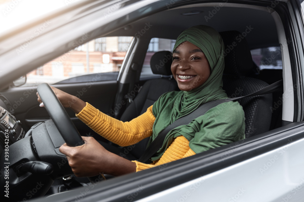 Road Trip. Black Muslim Woman In Hijab Enjoying Driver Car In City