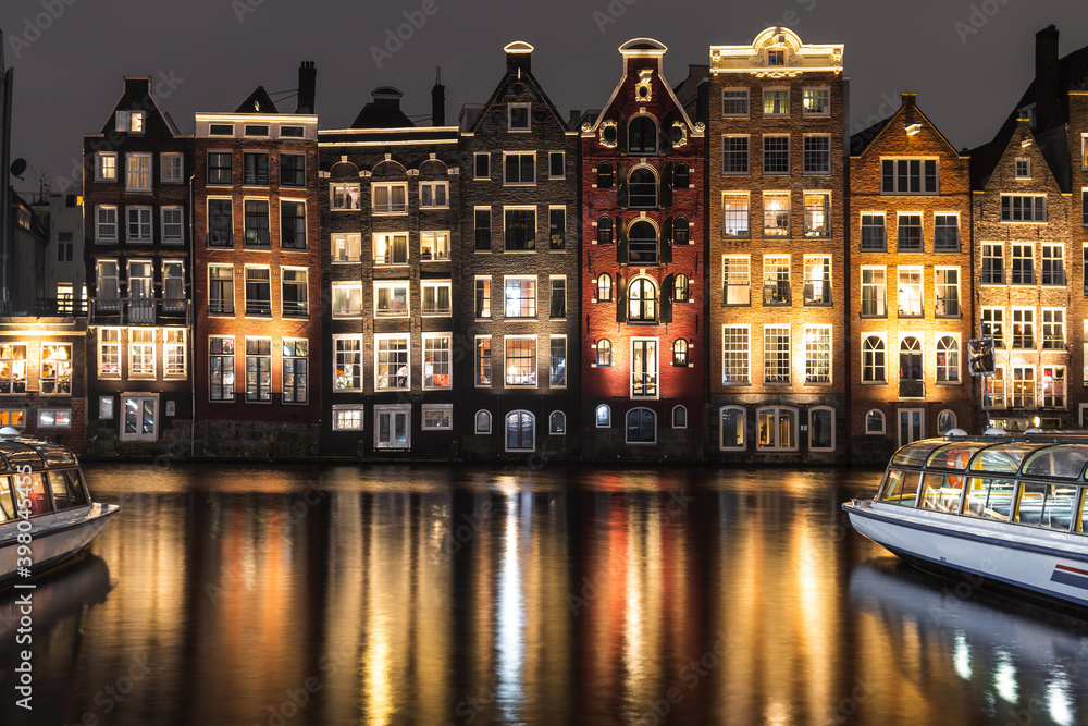 Amsterdam's houses near the canal at night.