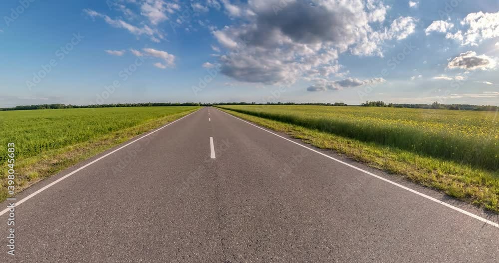 slow transformation of landscape into tiny planet on asphalt road among fields with blue sky and beautiful white clouds. curvature of space. slow transformation of landscape into tiny planet on asphalt road among fields with blue sky and beautiful white clouds. curvature of space.