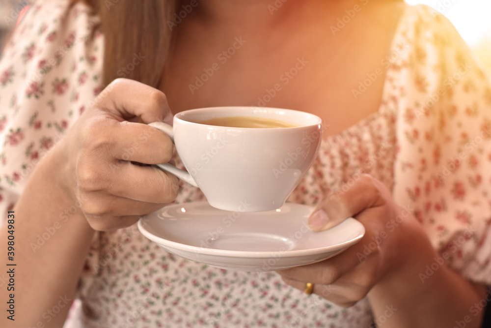 Morning coffee today, Coffee in white cup in woman hand with sunlight background. Morning coffee today, Coffee in white cup in woman hand with sunlight background.