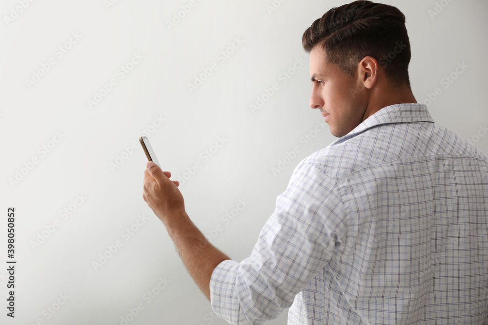 Man unlocking smartphone with facial scanner on white background. Biometric verification Man unlocking smartphone with facial scanner on white background. Biometric verification