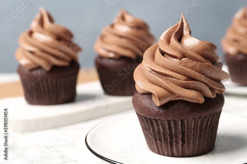 Delicious fresh chocolate cupcake on table, closeup photo