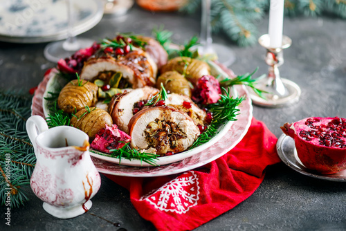 Prosciutto wrapped turkey roulade with pomergranate sauce. .style rustic. photo