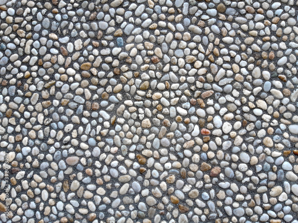 Colorful and round stones, stone wall texture, road made of small boulders and sea stones. Colorful and round stones, stone wall texture, road made of small boulders and sea stones.