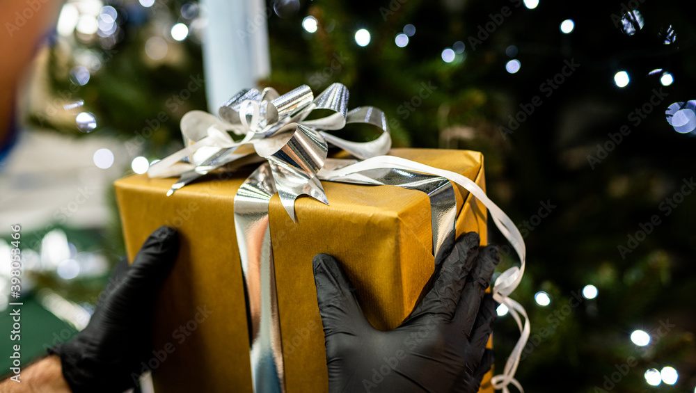gift - christmas holiday 2020 - handing a gift with gloves