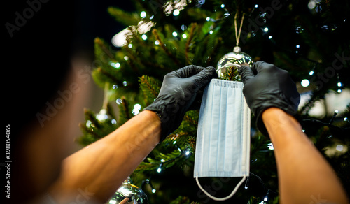 Obraz na płótnie decorating the Christmas tree - medical mask for the Christmas tree - coronavirus pandemic | COVID-19 | Merry Christmas - the realities of 2020 w salonie