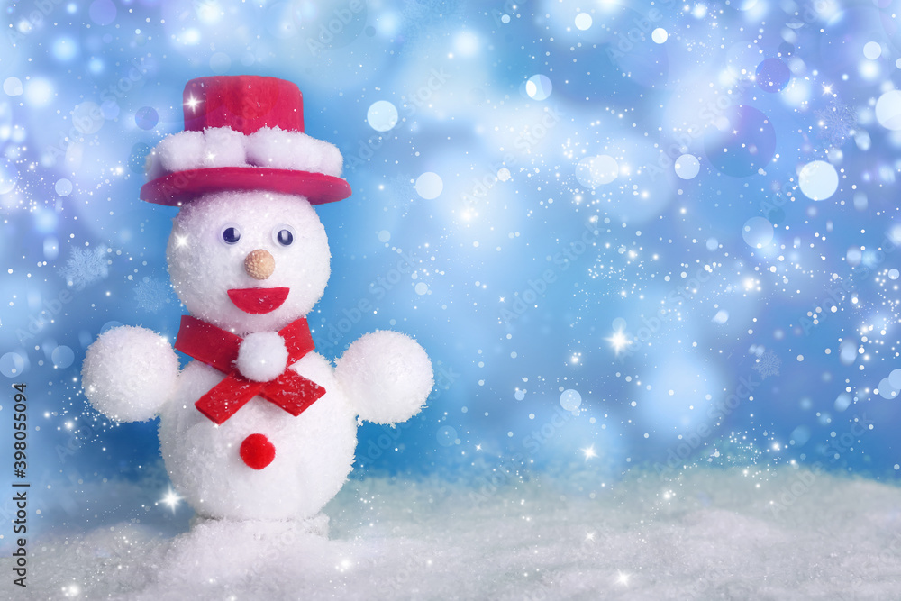 Cute decorative snowman on blue background, bokeh effect. Space for text