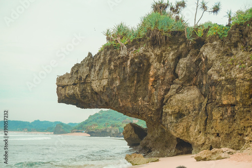 Beautiful rock looks like a giant aligator at Indrayanti beach, java - Indonesia