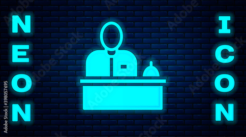 Glowing neon Receptionist standing at hotel reception desk icon isolated on brick wall background. Vector.
