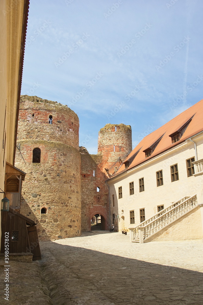 
Horizontal image of the Bauska Castle yard with blue sky in background on bright a summer day
