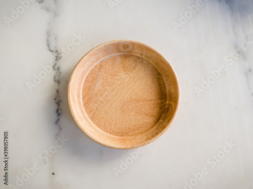 one wooden plate on white table