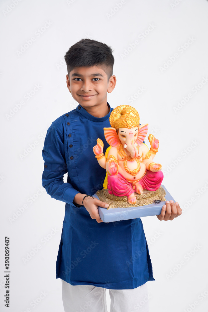 Indian little boy with lord ganesha , Celebrating Ganesh Festival Indian little boy with lord ganesha , Celebrating Ganesh Festival