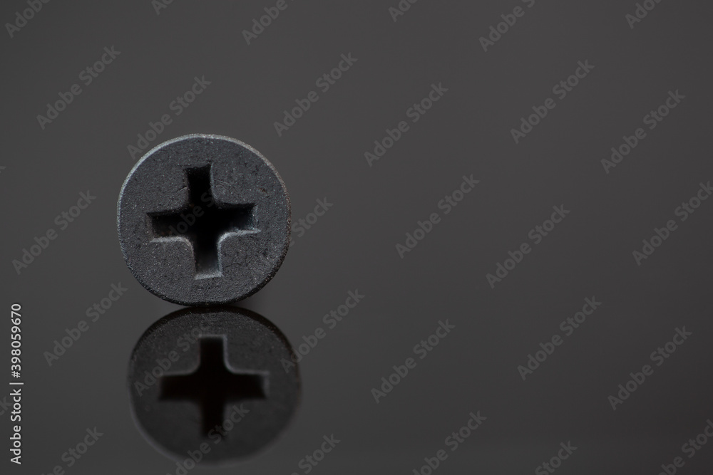 self-tapping screw on a dark background self-tapping screw on a dark background