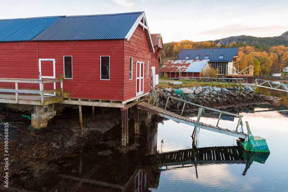 Norwegian fishing village, red wooden barn on coast