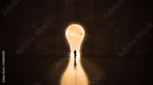 Businessman getting out from a dark room to  financial freedom. Exit through a lightbulb door, business idea or startup inspiration concept 