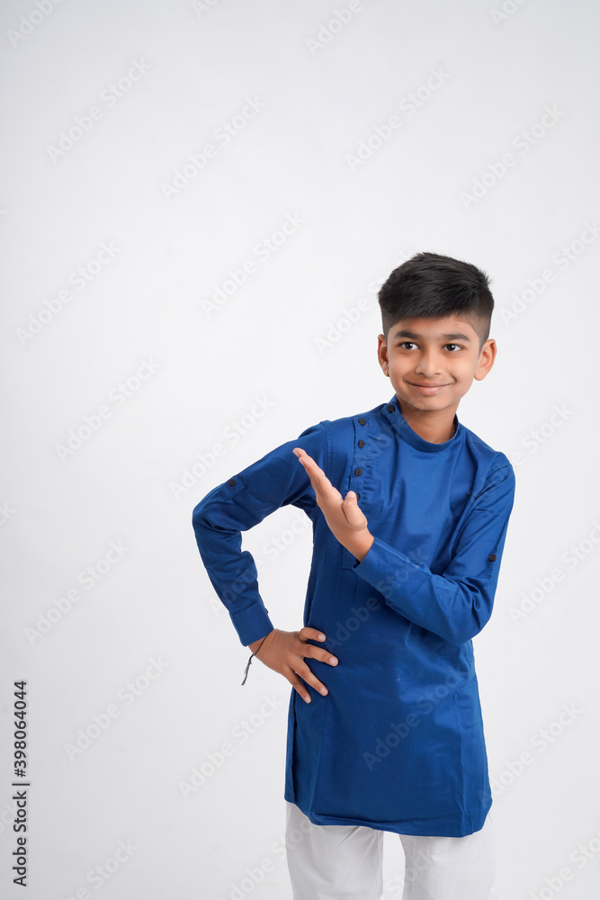 Cute indian little boy in ethnic wear and showing expression over white background Cute indian little boy in ethnic wear and showing expression over white background