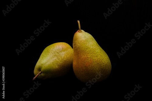 Two ripe pears on black background