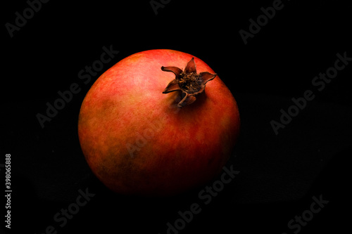 Ripe pomegranate fruit on dark background