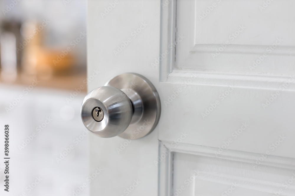 Door with grill, stainless door knob or handle on wooden door in