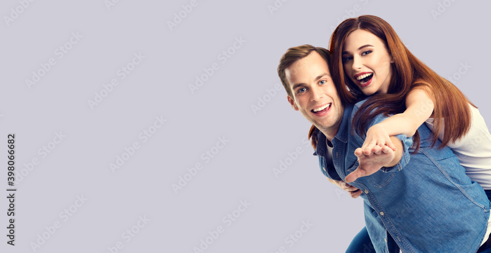 Obraz premium Love, relationship, dating, lovers, sales, romantic concept - happy excited couple, man and woman in piggyback pose, isolated over grey background. Copy space for text.