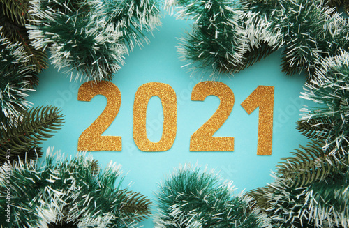 Happy New Year. Symbol from number 2021 and christmas decoration on blue wooden background. © Mouse family