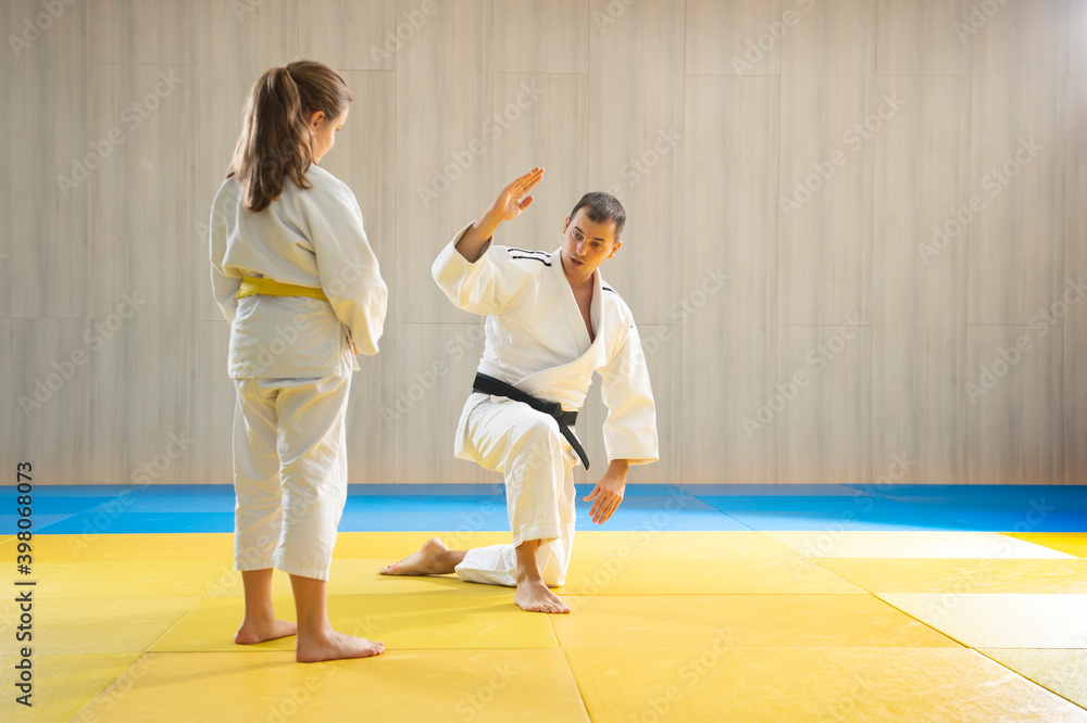 Judo master and young yellow belt judo girl Judo master and young yellow belt judo girl