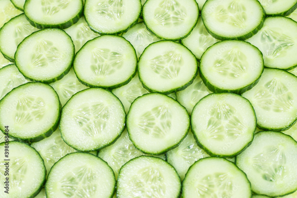 Fresh green slices of cucumber as background. Fresh green slices of cucumber as background.