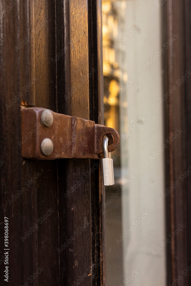 Closed Store due to Coronavirus pandemic. Locked Store Door with Padlock Closed Store due to Coronavirus pandemic. Locked Store Door with Padlock